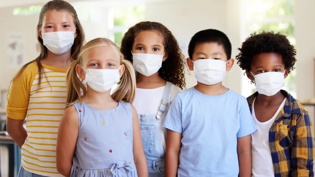 students standing in class with face masks on